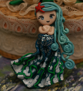 Water, in all it's elegance. The white and green on the dress are sea foam and sea weed. This one was fun to make, but I wish I had spent more time on her hair. 